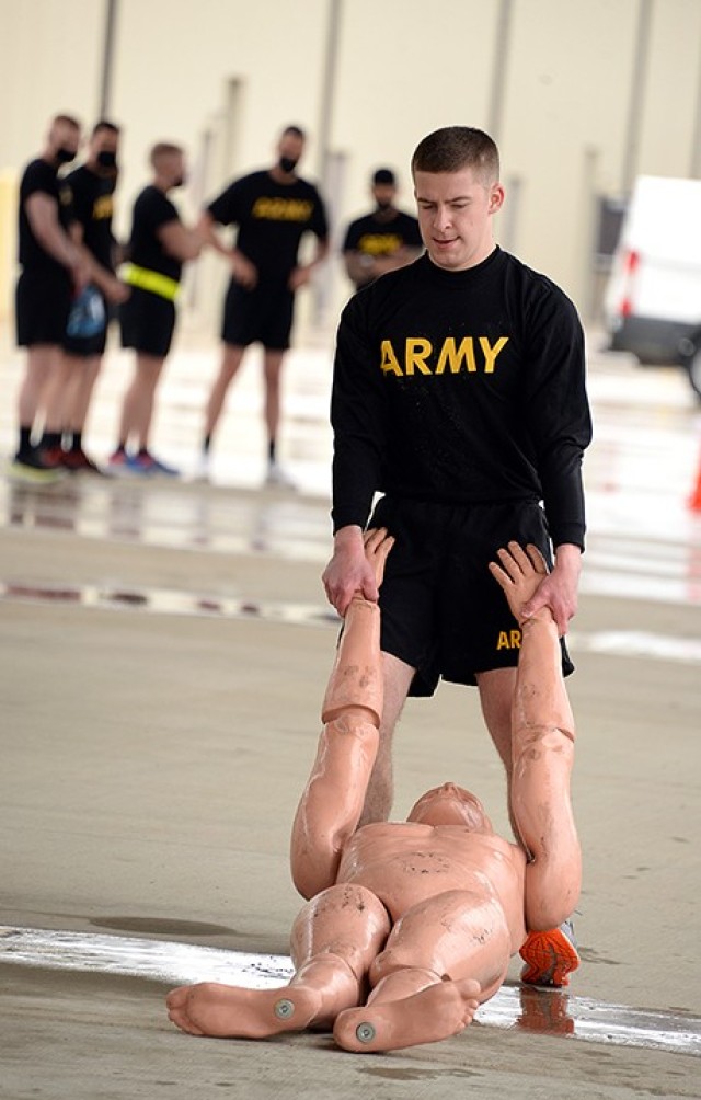 Competition participant 2nd Lt. Timothy Shively, 256th Military Police Company, 40th MP Battalion (Detention), drags a dummy for 100 meters in the Iron Griffin gauntlet course March 25 outside the company operations facilities. Shively and 1st Lt. Levi Gervasi, 291st MP Company, 40th, participated in the competition with the NCOs and soldiers, with Shively scoring as top officer. Photo by Prudence Siebert/Fort Leavenworth Lamp