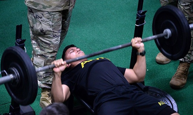 Sgt. Gilberto Garcia, 256th Military Police Company, 40th MP Battalion (Detention), performs bench press repetitions in the Iron Griffin fitness challenge during the 15th MP Brigade NCO and Soldier of the Year competition March 25 in the company operations facility. Garcia was named NCO of the Year for the 40th MP Battalion and will go on to represent Fort Leavenworth in the Combined Arms Center competition. Photo by Prudence Siebert/Fort Leavenworth Lamp