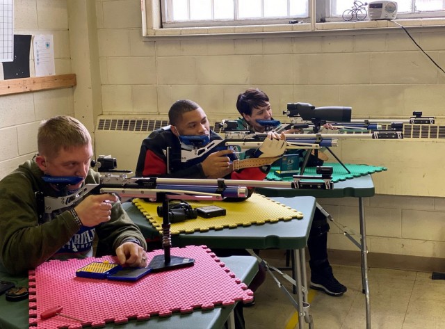 Maj. Kyle Eldridge (left), Sgt. Brandon Jenkins (center), Maj. Adriana de Julio (right) fire air rifles on Fort Carson, Colo., on March 12, 2021. During the 2021 Army Trials, de Julio competed in air rifle, archery and cycling events. (Photo...