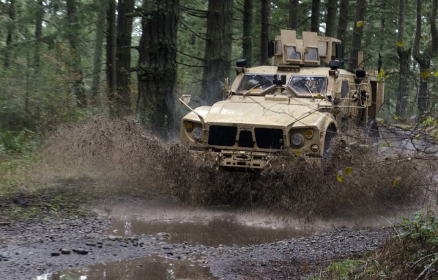 Motor transport operators from the 593rd Expeditionary Sustainment Command navigate a Mine-Resistant Ambush Protected vehicle familiarization course during the Master Driver Trainer Qualification Course at Joint Base Lewis-McChord, Wash. The...