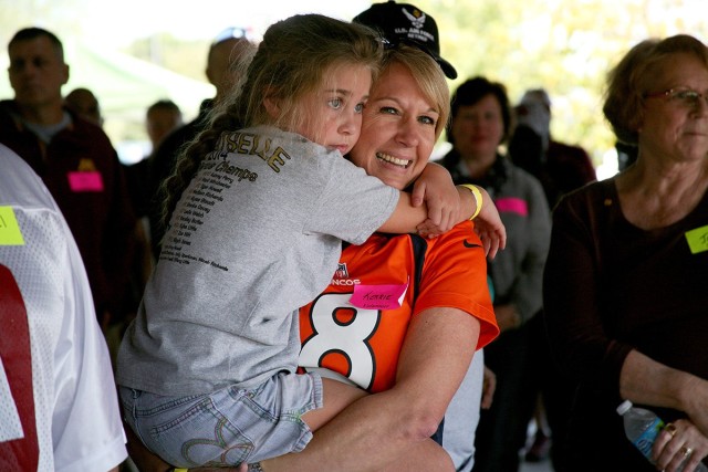 Kerrie Branson, Survivor Outreach Services coordinator for Redstone Arsenal, Alabama, holds Gold Star Family member Kylee Little during a U.S. Army Space and Missile Defense Command-sponsored fall festival at the Huntsville Botanical Gardens on...