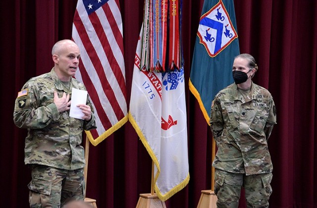 Col. Thomas Bolen, Combined Arms Center chief of staff, thanks Women's History Month observance guest speaker Lt. Corrie Hanson, 705th Military Police Battalion (Detention) commander, for her remarks and tells her that she served as a good role model for his daughter, 2nd Lt. Katie Bolen, during a pre-Basic Officer Leader Course internship that his daughter spent at the 15th MP Brigade last fall, at the conclusion of the Women's History Month observance March 26 in Grant Auditorium. Photo by Prudence Siebert/Fort Leavenworth Lamp