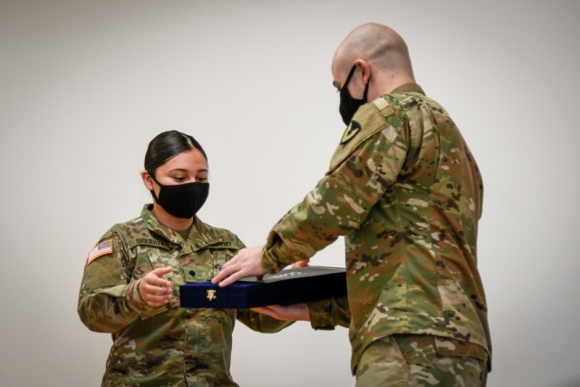 CAMP HUMPHREYS, Republic of Korea - Spc. Ian Holmes, the Humphreys Better Opportunities for Single Soldiers (BOSS) President and a CH-47 helicopter repairer assigned to Installation Management Command, right, presents a commemorative plaque to...