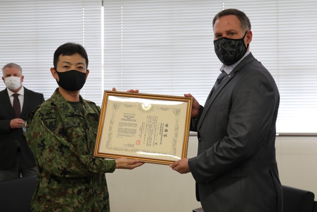 Daniel Brush, right, U.S. Army Garrison Japan Directorate Emergency Services director, poses with a certificate of appreciation he received from Col. Kazuya Ono, left, commander of the JGSDF’s 4th Engineer Group and JGSDF Camp Zama during a...