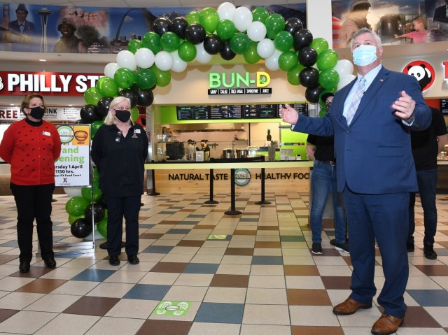 Eric Wagenaar, Fort Drum deputy to the garrison commander, welcomes customers to the grand opening of the new Bun-D restaurant at the Exchange food court on April 1. Senior leaders across Fort Drum and 10th Mountain Division (LI) have explored a variety of ways to encourage Soldiers to make healthier food choices. (Photo by Mike Strasser, Fort Drum Garrison Public Affairs)