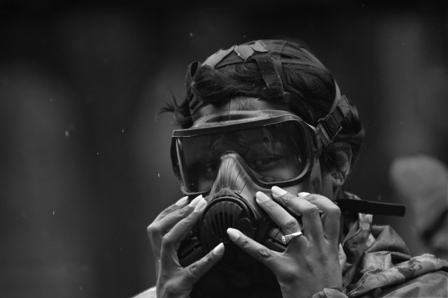 Staff Sgt. Tiffanie Pulley, 217th Military Police Detachment, makes adjustments to her protective mask during chemical, biological, radiological and nuclear training April 1 at the range training complex. She was one of 35 unit members to undergo...