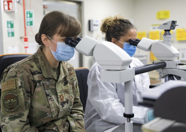 U.S. Air Force Capt. Mary Storey, chief, Core Laboratory, Landstuhl Regional Medical Center, inspects a laboratory technician's work at LRMC, March 21. Storey, a native of Indian Heights, Indiana, was recognized as the 86th Airlift Wing's Company Grade Officer of the Year, for her contributions to Joint-Service efforts to combat the spread of COVID-19 as part of LRMC. Assigned to U.S. Air Forces in Europe and Air Forces Africa, the 86th AW is the parent organization of seven groups and 30 squadrons across four military installations in Germany, Spain, Belgium and Portugal.