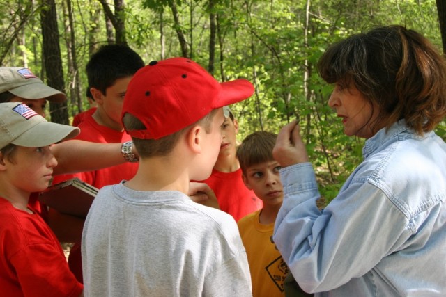 Linda Carnes-McNaughton, program archaeologist and curator, Fort Bragg’s Cultural Resources Management Program, Directorate of Public Works, teaches a group of Scouts how to test if an item is ceramic by touching it with their tongue during a...