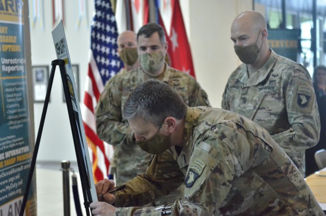Major General JP McGee, commanding general, 101st Airborne Division (Air Assault) and Fort Campbell, signs the Sexual Harassment Assault Response Prevention pledge during a proclamation signing March 30 at Division Headquarters. Also pictured,...