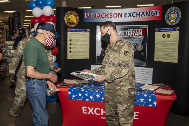 Garrison Commander Col. John 'Wes' Hankins presents Navy veteran Perry Riley with a Vietnam Veteran Lapel Pin March 29 at the Fort Jackson Exchange.