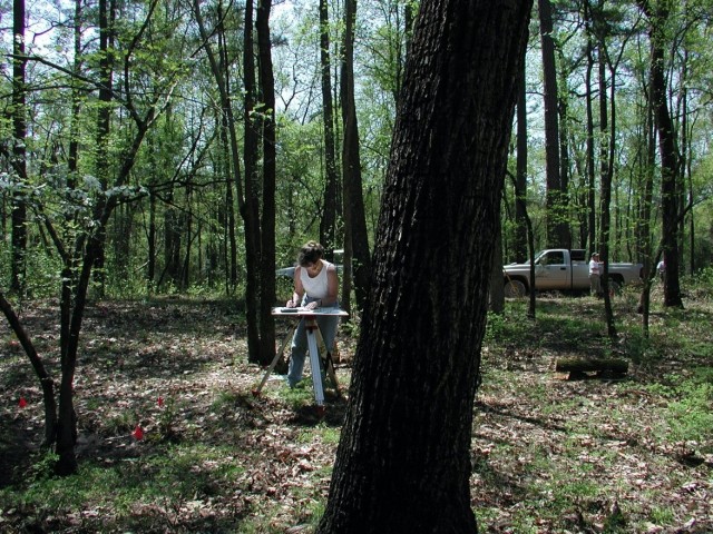 Linda Carnes-McNaughton, program archaeologist and curator, Fort Bragg’s Cultural Resources Management Program, Directorate of Public Works, working in the field mapping the John Lamont home site on Fort Bragg, 2005.