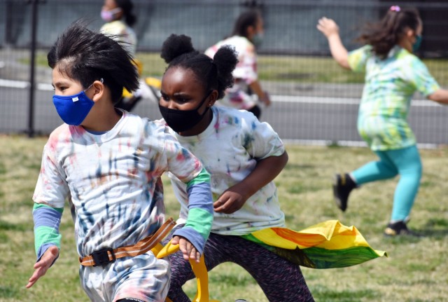 AnneGrace Meechem, right, a third-grader, gets ready to pull the flag of Leo Fusero, a second-grader, during the 2021 School Age Center Olympics at Sagamihara Family Housing Area, Japan, April 1.