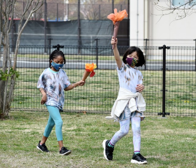 Emma Owen, right, and Cymone Vaughn, second-graders, participate in the opening ceremony of the 2021 School Age Center Olympics at Sagamihara Family Housing Area, Japan, April 1.