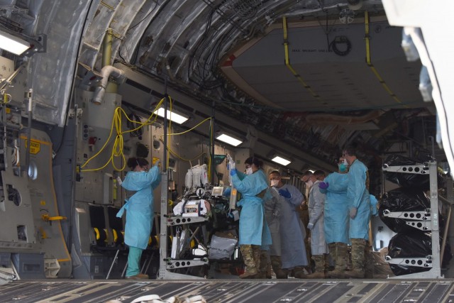 A COVID-19 patient who was being cared for at Madigan Army Medical Center, is loaded onto a C-17 Globemaster III by an aeromedical evacuation team from the 775th Expeditionary Aeromedical Evacuation flight from Travis Air Force Base, California,...