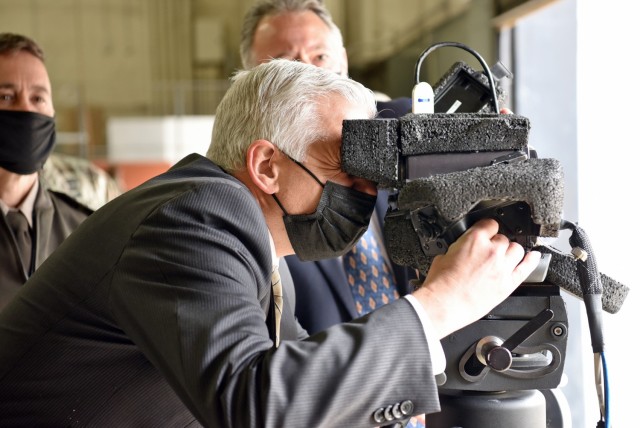Christopher J. Lowman, the senior official performing the duties of Under Secretary of the Army, focuses the cross-hairs on a simulated target while peering through the Javelin Lightweight Command Launch Unit lens while visiting with Program...