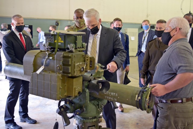 Christopher J. Lowman, the senior official performing the duties of Under Secretary of the Army, scopes out the Tube-Launched, Optically Tracked, Wireless-Guided, Improved Target Acquisition System with Jason Morris, TOW ITAS lead engineer, during...