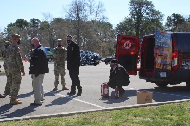 Firefighters from the Fort Knox Fire Department demonstrate how to use a fire extinguisher during  the 1st Theater Sustainment Command safety stand down, April 2, 2021 in front of the headquarters building at Fort Knox, Kentucky. They also...