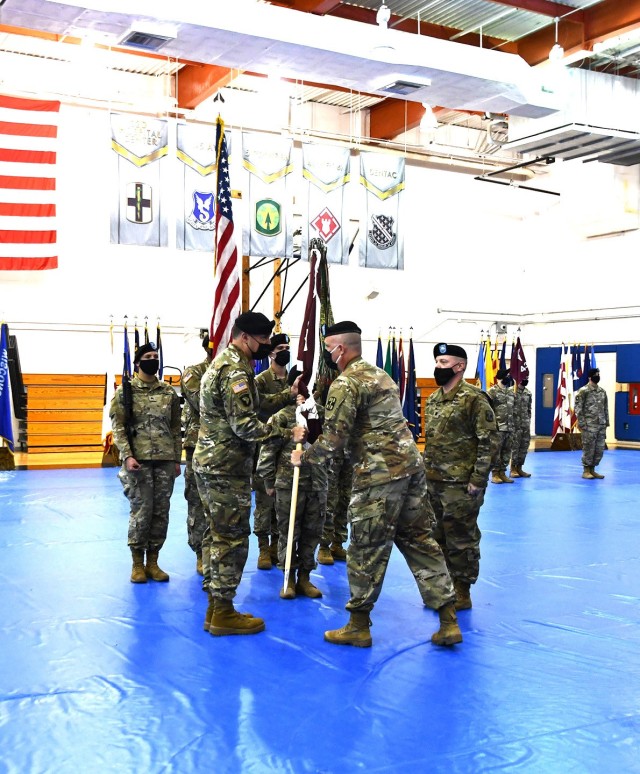 Col. Lee C. Freeman, (right) 32nd Hospital Center commander, passes the colors to Lt. Col. Stephen M. Duryea, 115th Field Hospital’s incoming commander, in a change of command ceremony held April 1 at Fort Polk’s Warrior Fitness Center.