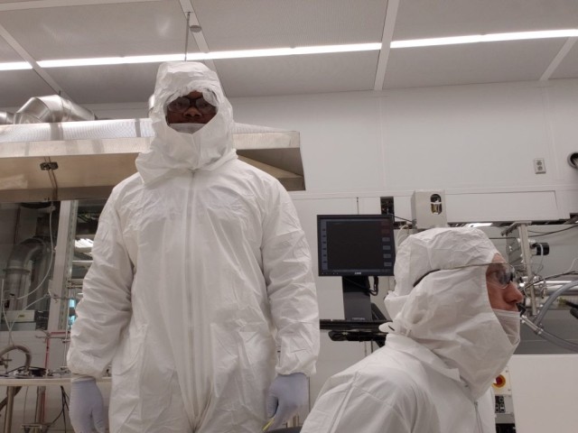 The author, left, learning to fabricate gold wafers using electron beam deposition tools within the 