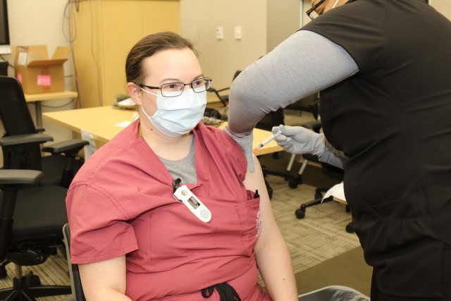 Capt. Mary Roelofs, a family physician with Weed Army Community Hospital, is vaccinated with the Moderna COVID-19 vaccine Dec. 23, 2020, at Weed ACH on Fort Irwin, Calif., during Tier 1 vaccinations. As of April 7, Fort Irwin is in Tier 2 and...