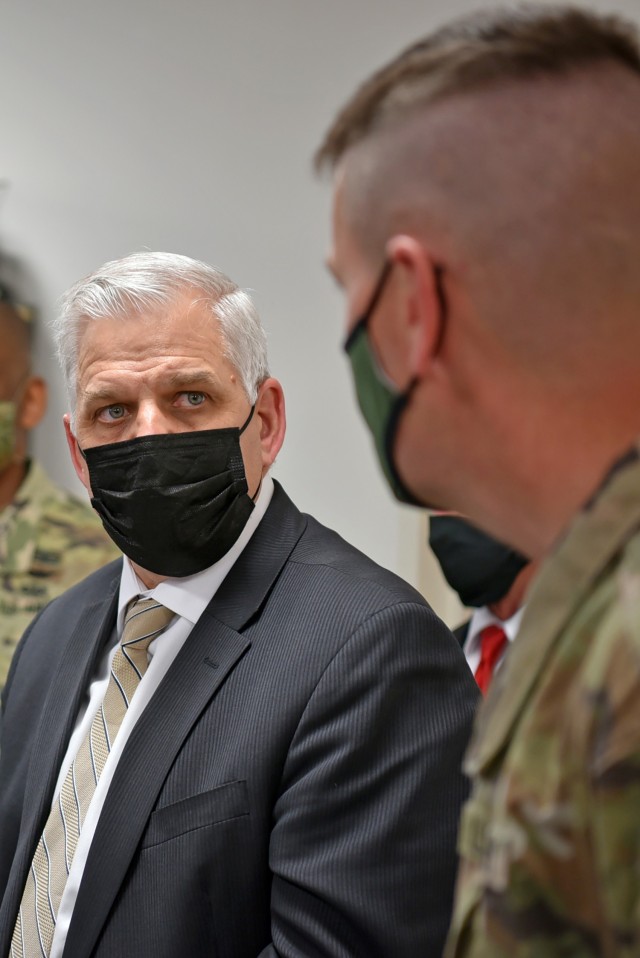Christopher J. Lowman, the senior official performing the duties of the Under Secretary of the Army, tours the Integrated Air and Missile Defense Battle Command System lab March 23 at Redstone Arsenal, Alabama, with Col. Phil Rottenborn, Program...