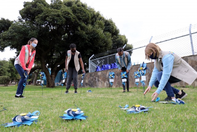 From left, Jane Dalton, 12; Madison Swanigan, 13; Naomi Thomas, 14; and Kaitlyn Dodson, 12, members of Girl Scout Troop 600, plant pinwheels in honor of National Child Abuse Prevention Month at Camp Zama, Japan, April 6.