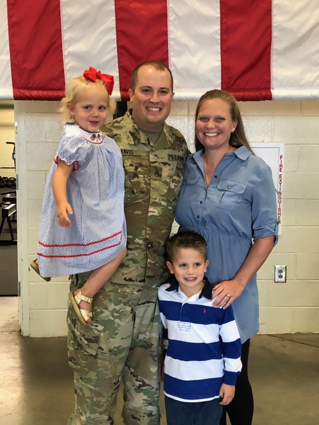 Staff Sgt. John ‘Jordan’ Travis, domestic operations management support, emergency operations center, NCOIC, poses with his wife and two children. “Being a military child and now being in the military with children of my own has really given me a sense of purpose and direction,” said Travis. (Courtesy photo from family.)