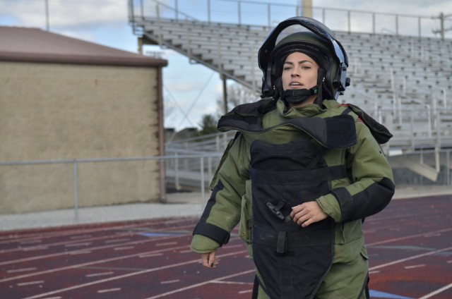 Captain Kaitlyn Hernandez, commander, 717th Ordnance Company, 52nd Ordnance Group (Explosive Ordnance Disposal), trains at Fryar Stadium March 28 in preparation to set the Guinness World Record for the fastest woman to run 1-mile in a bomb suit.