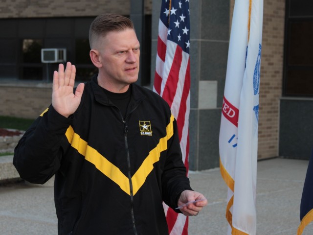 Maj. Gen. Darren Werner, Commanding General U.S. Army Tank-automotive and Armaments Command, administers the oath of enlistment to Sgt. 1st Class Fransheska Wiggins Apr. 8 at the Detroit Arsenal, Mich.  Wiggins organized a run/walk event for...