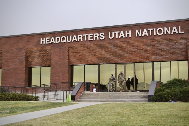 Army Reserve Capt. Melissa Powers, left, officer in charge, and Sgt. Kevin Kiffen, senior enlisted leader, both with the 90th Military History Detachment, depart the Utah National Guard Headquarters in Draper, Utah, Nov. 18, 2020. The 90th MHD has conducted more than 100 interviews with key participants in the U.S. Army's COVID-19 response since being mobilized in April 2020. (U.S. Army photo by Sgt. Sami Abdelaziz)