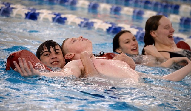 Lifeguard training students 15-year-old Jonathan Purvis, 19-year-old Peter Teachout, 17-year-old Presley Lombardo and 16-year-old Chloe Thompson practice rescues, taking turns in the roles of rescuer and drowning victim, during Red Cross...