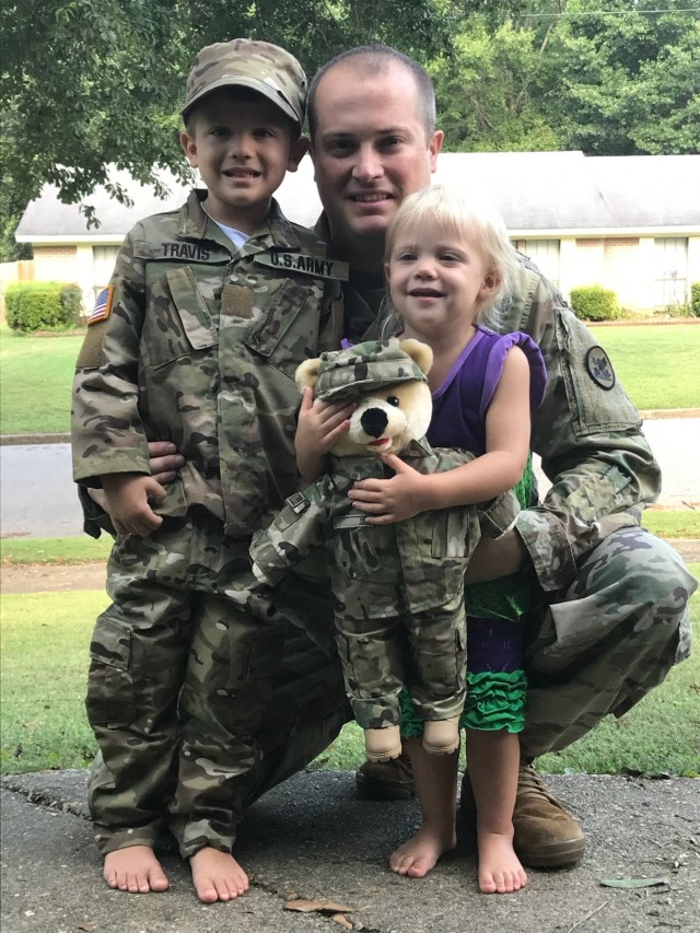 Staff Sgt. John ‘Jordan’ Travis, domestic operations management support, emergency operations center, NCOIC, poses with his two children. (Courtesy photo from family.)