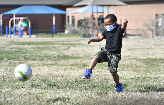 Isaiah Hubbard demonstrates kicking a soccer ball April 7 at the Child Development Center complex. His demonstration was similar to requirements for entering the Virtual Soccer Kickoff Challenge that concluded April 6 here. Seventy school-agers...