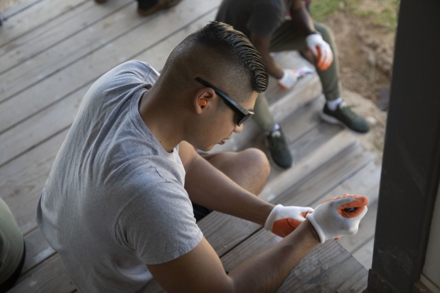 An Alpha Company, 209th Aviation Support Battalion (ASB), 25th Combat Aviation Brigade (CAB)soldier smooths wooden surfaces in preparation for painting while working with Habitat for Humanity, to continue construction on a home being built in Kapolei, Hawaii.
