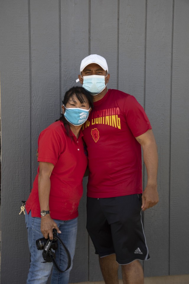 Sgt. Vance Brown and Ms. Jo Bautista the Executive Director of Habitat for Humanity pose for a photo at a construction site in Kapolei, Hawaii. Brown coordinated with Bautista to organize the volunteer event for the 209th Aviation Support Battalion.