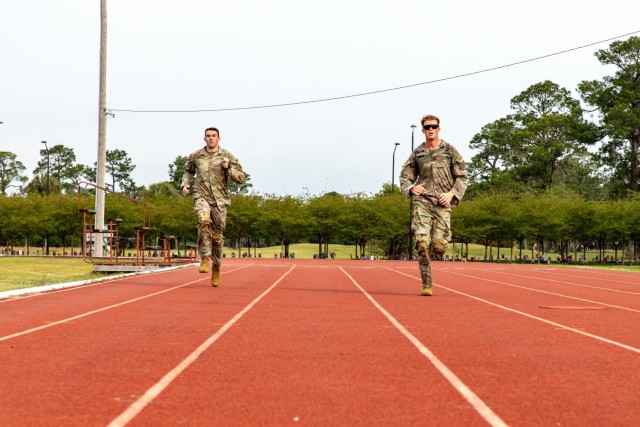 U.S. Army 1st Lt. David Stanley and 1st Lt. Zachary Hobson, both infantry officers assigned to 1st Armored Brigade Combat Team, 3rd Infantry Division, sprint 100 meters after completing a 24-mile ruck, April 9, 2021, on Fort Stewart, Georgia. Both Soldiers, who were deployed in South Korea, traveled to Georgia to participate in the upcoming Best Ranger Competition slated to take place at Fort Benning, Georgia, April 16-18. (U.S. Army photo by Pfc. Summer Keiser)