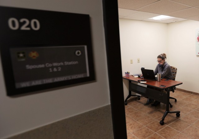Army spouses Kristina Woestman and Olga Hansen telework from the newly opened co-work stations in Building 1378. Woestman says she enjoys having somewhere to work free of family distractions.