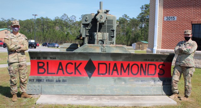 U.S Army 1st Lt. Andrew Wilhelm, a route clearance platoon leader, and 1st Lt. Madison Jones, an executive officer, both assigned to 92nd Engineer Battalion, pose in front of their unit bulldozer on Fort Stewart, Georgia, April 7, 2021. They will...