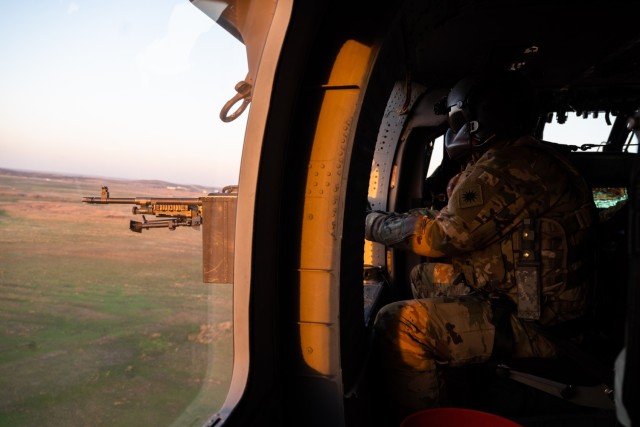 Spc. David Ngo, a UH-60 Black Hawk crew chief with C Company, 1st Assault Helicopter Battalion, 140th Aviation Regiment, Washington National Guard, engages targets during aerial gunnery qualifications at Fort Sill, Oklahoma, March 30, 2021.
