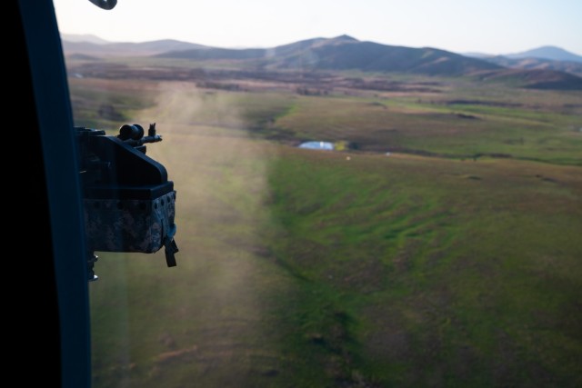 Spc. David Ngo, a UH-60 Black Hawk crew chief with C Company, 1st Assault Helicopter Battalion, 140th Aviation Regiment, @Washington National Guard, engages a pond serving as a target for aerial gunnery qualifications at Fort Sill, Oklahoma, March...