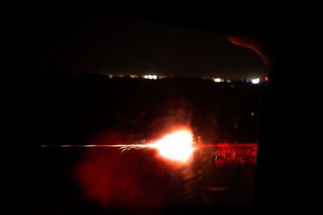 Sgt. Christopher Armenta with C Company, 1st Assault Helicopter Battalion, 140th Aviation Regiment, Washington National Guard, fires an M240H machine gun during aerial gunnery qualifications night fire at Fort Sill, Oklahoma, March 30, 2021.