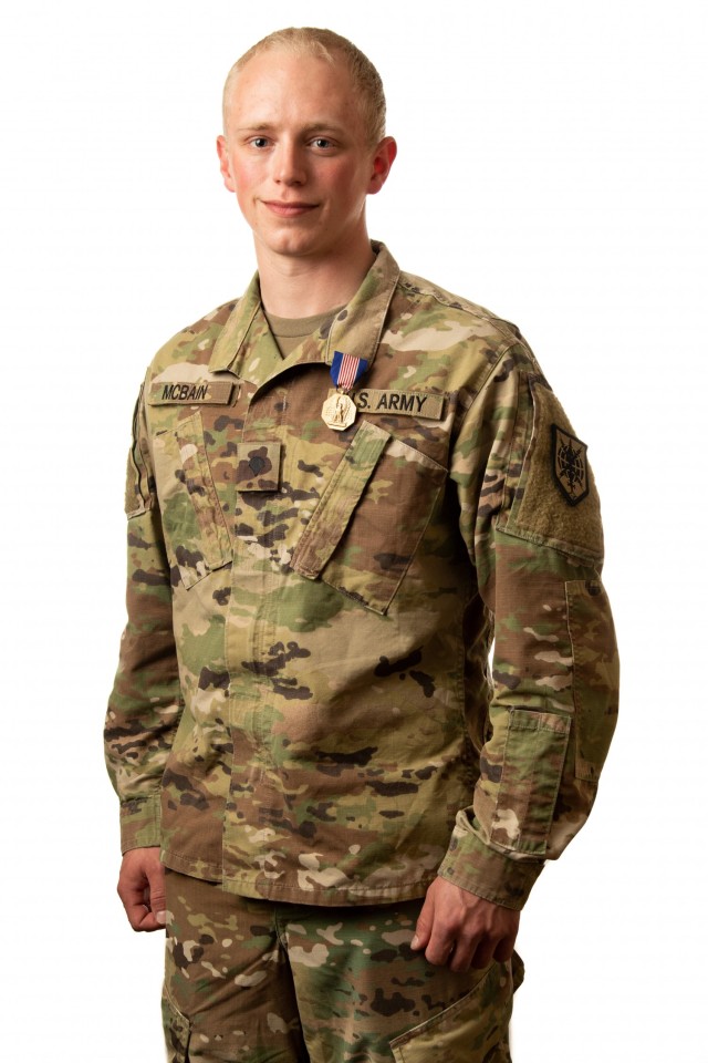 Spc. Justice McBain, recipient of the Soldier’s Medal, poses for a photo after the presentation ceremony April 11, 2021, at Milwaukee, Wisconsin. (U.S. Army Reserve photo illustration by Maj. Jeku Arce) (This photo has been altered by extending the white backdrop evenly throughout the frame.)