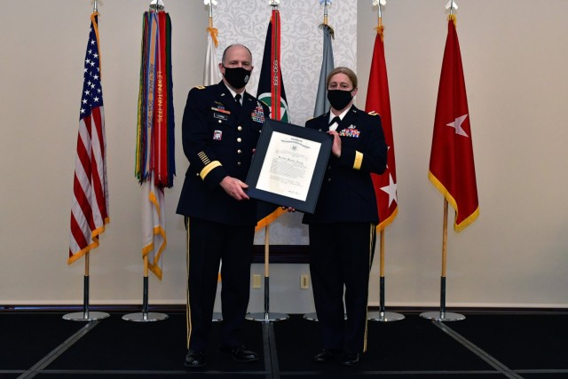 U.S. Army Gen. Stephen R. Lyons, commander U.S. Transportation Command, presents U.S. Army Brig. Gen. Heidi J. Hoyle with her promotion to major general order during a ceremony in her honor at the Scott Air Force Base, Ill. event center April 9,...