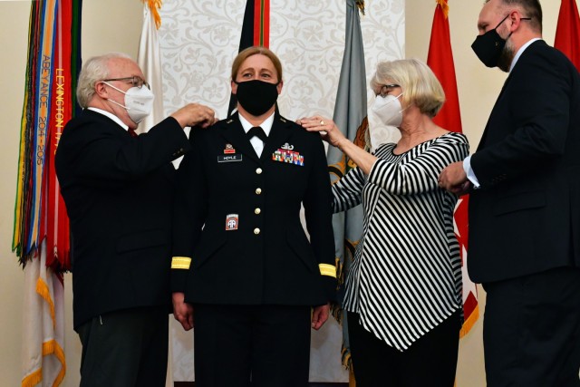 U.S. Army Brig. Gen. Heidi J. Hoyle, the commanding general of Military Surface Deployment and Distribution Command, has her promotion to major general stars pinned on by her parents and husband during a ceremony in her honor at the event center...