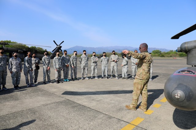 Staff Sgt. Benjamin Ivy, right, a crew chief assigned to the U.S. Army Aviation Battalion Japan, briefs cadets on safety before their Black Hawk flights during the Zama Middle High School Junior Reserve Officers’ Training Corps Cadet Leadership...
