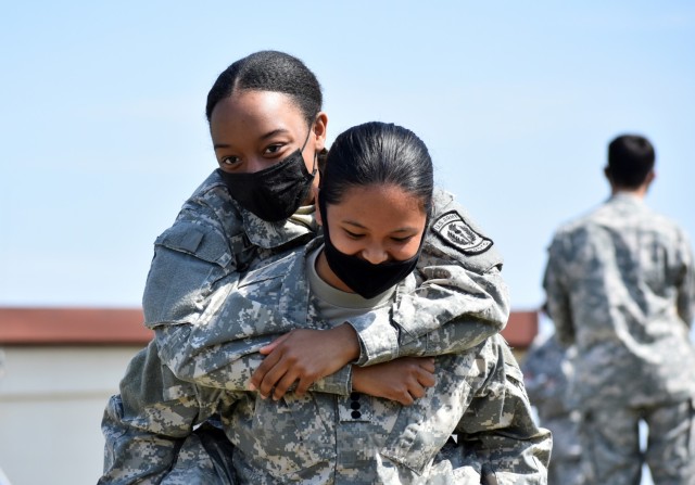 Cadet Capt. Raelyn Flores, right, practices a medical rescue carry with Cadet Staff Sgt. Theori Lindsay during the Zama Middle High School Junior Reserve Officers’ Training Corps Cadet Leadership Challenge at Kastner Army Airfield, April 8.