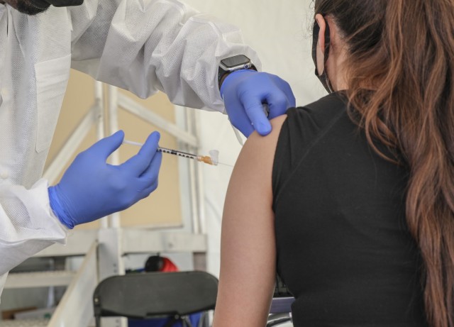 Sidney Ty Branch with Las Vegas Paiute Tribe Healthcare administers the Janssen vaccine to a tribal member at the mobile vaccination unit site, Tuesday, April 6, 2021 at the Paiute Indian Tribe in Las Vegas, Nevada.
