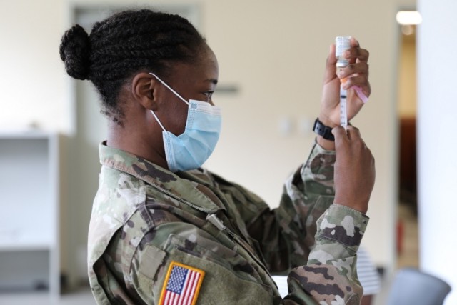 Pfc. Shaniah Edwards, assigned to the Virgin Island National Guard medical detachment, prepares to administer a COVID-19 vaccine to Soldiers at the Joint Force Headquarters in St. Croix, U.S. Virgin Islands, Feb. 12, 2021. 