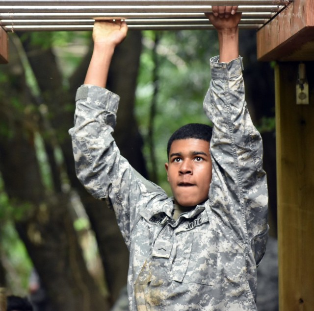 Cadet Pvt. Stanley Green completes the monkey bars portion of the obstacle course during the Zama Middle High School Junior Reserve Officers’ Training Corps Cadet Leadership Challenge at Camp Zama, Japan, April 6.