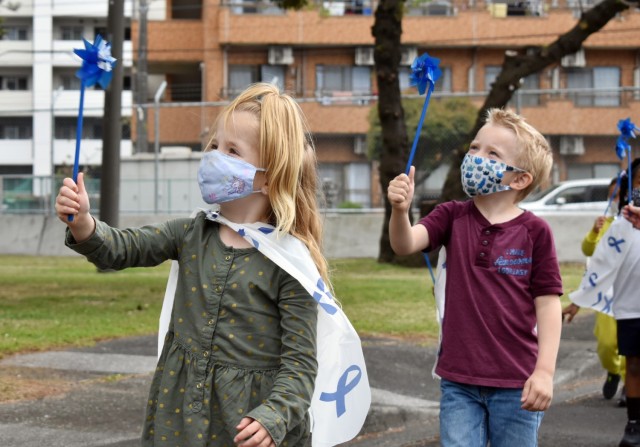 Reyna Coleman, 5, left, and William Jamieson, 4, watch their pinwheels spin during a superhero parade at the Child Development Center at the Sagamihara Family Housing Area, Japan, April 9. Camp Zama Family and Morale, Welfare and Recreation...
